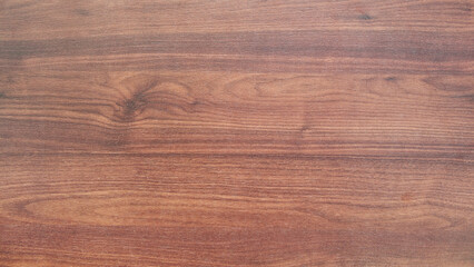 Poster - A wooden surface with a grain pattern. The wood is brown and has a natural texture. The surface is smooth and has no visible blemishes