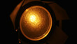 © Imagehub - Close up of a glowing round light source inside a dark metallic fixture.