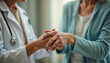 © Imagehub - Doctor and patient holding hands  showing empathy and support during a consultation.