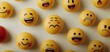 © Kittipong - Emotive Diversity Closeup of Vivid Emoticon Spheres on Beige Surface, Featuring Sad Yellow Face. Mood Contrast in Conceptual Composition for Emotional Intelligence Illustration
