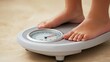 © phianguma - A close-up of a person stepping on a scale, representing the moment of weighing in during a weight loss journey