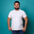 © Anomal - joyful young hispanic plus size body positive male man boy guy 30s in white blank design casual t-shirt posing color background studio portrait