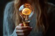 © Alina - Digital brain inside a lightbulb in businesswoman hand, artificial intelligence technology
