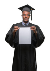 Wall Mural - Young graduated african american man holding blank paper degree over isolated background with a confident expression on smart face thinking serious