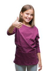 Young beautiful girl over isolated background doing happy thumbs up gesture with hand. Approving expression looking at the camera with showing success.