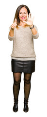 Canvas Print - Beautiful middle age woman wearing fashion sweater showing and pointing up with fingers number six while smiling confident and happy.