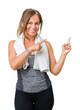 © Krakenimages.com - Beautiful middle age woman wearing sport clothes and a towel over isolated background smiling and looking at the camera pointing with two hands and fingers to the side.