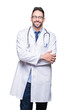 © Krakenimages.com - Handsome young doctor man over isolated background happy face smiling with crossed arms looking at the camera. Positive person.