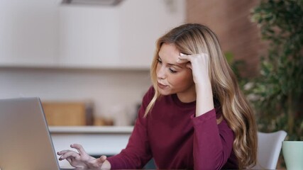 Wall Mural - Video of worried and angry woman working with laptop in living room at home.