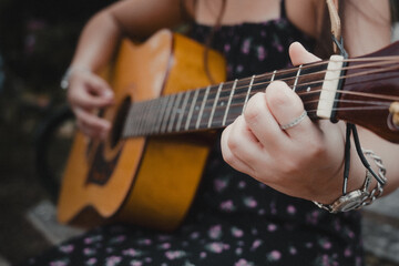 person playing an acoustic guitar