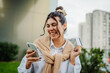 © Dusan - Young caucasian woman using credit card outside to pay from her phone