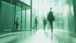 © AndiAzis - Silhouetted Business People Walking Through Modern Glass Office Building Lobby, Green Tinted Sunlight