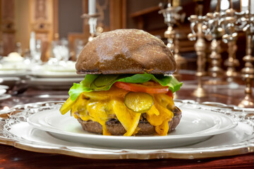 Wall Mural - Traditional rustic burger sandwich with cheddar cheese, vegetables and Australian bread in creative photography and cozy village setting