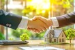 © SyedaJakeaBegum - A real estate agent shaking hands with their client after signing the home purchase contract, next to them is a small house model and keys on the table
