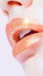 © Phisan - Close-up of glittery, peach-colored lips with a shiny finish, showcasing a glamorous and stylish makeup look.