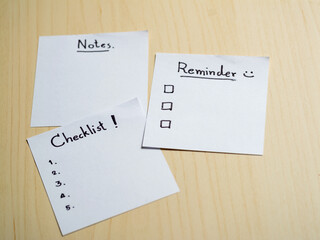 Poster - Organizing your life checklist notes and reminders on a wooden table home office conceptual view