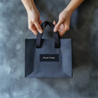 © NNS Studio - Black Friday paper bag held by hands retail advertising marketing campaigns seasonal discounts promotional content sophisticated web design digital minimalist grey simple holiday event shopping