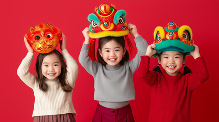 Three asian children holding colorful dragon masks celebrating lunar new year