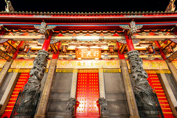 Wall Mural - Night view of Xingtian Temple building in Taipei, Taiwan. The temple is devoted to Lord Guan. In 2014, it's became the first in Taiwan to ban the burning of incense.