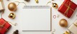 © VirtualVista - Christmas gifts ornaments and a blank notebook for festive messages arranged on a bright white background to capture holiday spirit