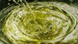 © Giovanni - Macro close up of liquid hemp oil being poured into a jar highlighting its texture and natural color for herbal and ecological products