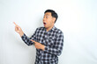 © M Alfan Setyawan - shocked asian man pointing finger with scared face isolated on white wearing casual shirt