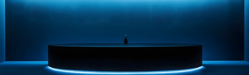 Wall Mural - sleek black podium on a bold electric blue background, softly illuminated, creating an expansive spa