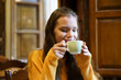 © javiindy - Savoring and relishing a cozy, warm, and relaxing moment with a delightful cup of coffee
