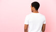 © luismolinero - African American man on copyspace pink background in back position and looking side