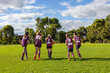 © Austockphoto - five kids on football oval running away for warming up at training