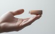 © Sergey Fedchenko - Hand Holding a USB Drive Hand holding a compact and modern USB flash drive with a metallic finish, on a white background.