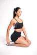 © kitthanes - an asian woman is working out wearing the sport exercise suit with white background,