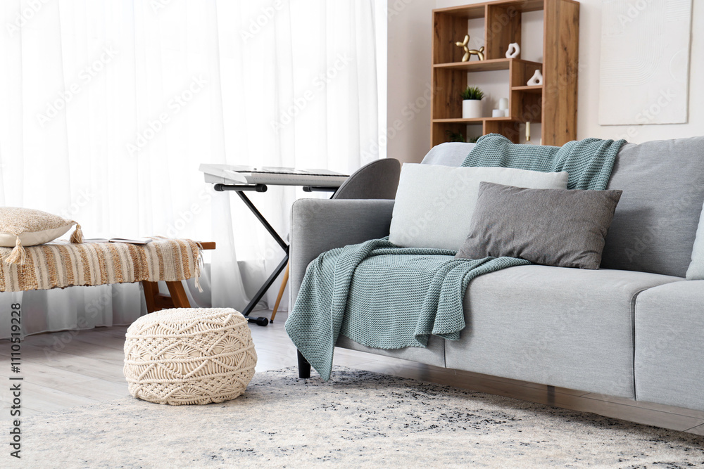 Interior of living room with sofa, synthesizer and bench