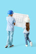 © Pixel-Shot - Cute little architects with blueprint on blue background, back view
