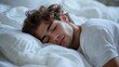 © Olga - Serenity of a young man sleeping in a comfortable bed for a relaxation concept design