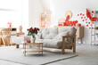 © Pixel-Shot - Interior of light living room decorated for Valentine's Day with sofa, table and gifts