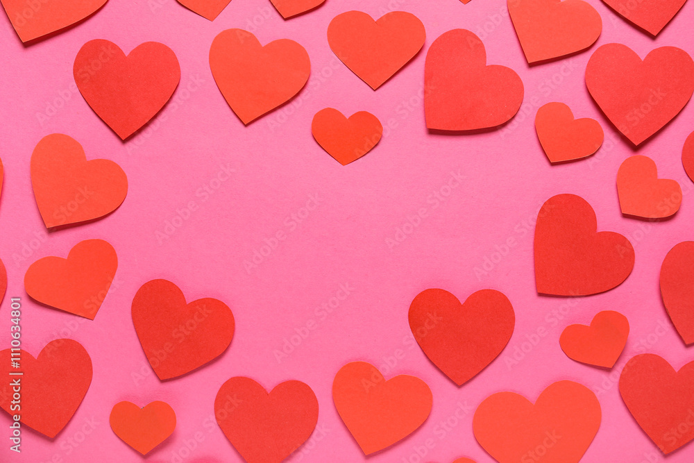 Frame made of red paper hearts on pink background. St. Valentine's Day.