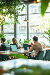 Programmers working in modern green office using laptop computers