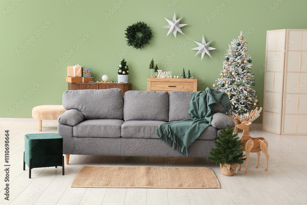 Interior of living room with Christmas trees and sofa