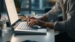 © Global Stock - A photo of a person typing on a keyboard in an office