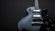 © Martinesku - Close up of vintage black electric guitar on dark background. Copy space for logo or text, banner concept.
