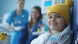 © Samady - A child cancer patient receiving treatment in a pediatric oncology unit, surrounded by supportive staff