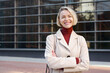 © EFStock - Confident female executive employee of modern business company. Portrait of happy professional blond woman outside the office workplace