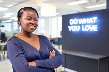 Sticker - Attractive unique African American female with blue blouse smiling at camera near trendy neon sign