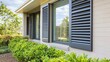 © Intach - Outside shutters and roller blinds on windows of a modern home, enhancing privacy while contributing to the clean, minimalist exterior design
