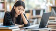 © Handz - Young Woman Studying Tiredly at Her Laptop