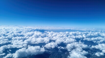 Wall Mural - Expansive aerial view of fluffy clouds under a blue sky