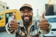 © SerPak - A joyful man with glasses and a cap shows enthusiasm by giving two thumbs up. He stands in an urban environment with yellow and white vehicles in the background, capturing a moment of positivity and e