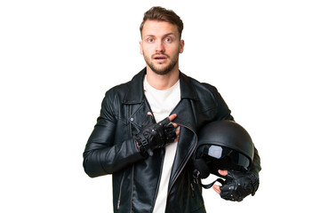 Wall Mural - Young caucasian man with a motorcycle helmet over isolated chroma key background surprised and shocked while looking right