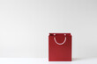 © RooM The Agency - Close-up of a red Shopping bag with handles that look like a smiley face